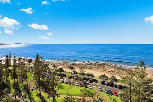 an aerial view of a parking lot next to the beach at Malibu Apartments in Mooloolaba