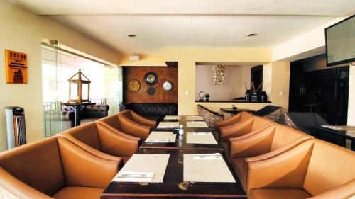 a dining room with a long table and leather chairs at La Riviera Hotel in San Antonio