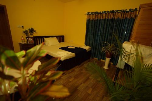 a small room with a bed and a window at Namasthe Ayurveda and Yoga Retreat Cochin in Nedumbassery