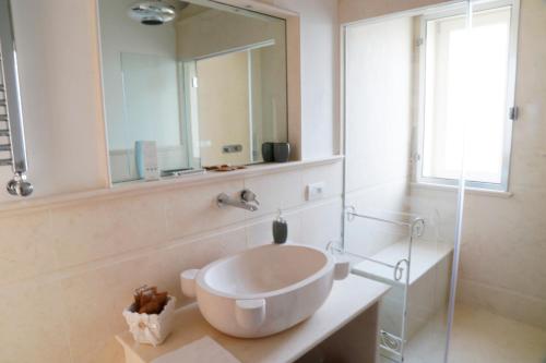 a bathroom with a large sink and a mirror at Villa Angelina in Selva di Fasano