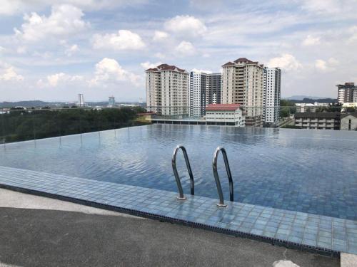 a swimming pool on the roof of a building at Yenni Duplex @ DeCentrum, Kajang in Serdang