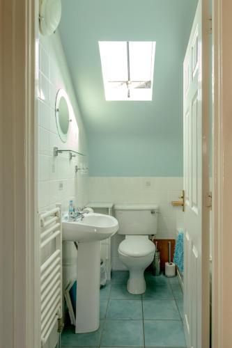 a bathroom with a white toilet and a sink at The Loft, Inverness in Inverness