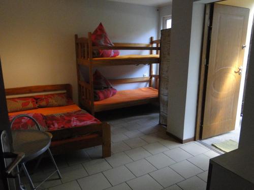a room with two bunk beds and a table at Sławska Poręba in Sława