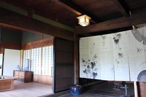 a room with a wall with a painting on it at Kamakurayama Farm - B&B Satoyama in Uda