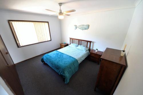 a bedroom with a bed and a ceiling fan at Sandy Feet at Hat Head - No Sheets or Towels Provided in Hat Head