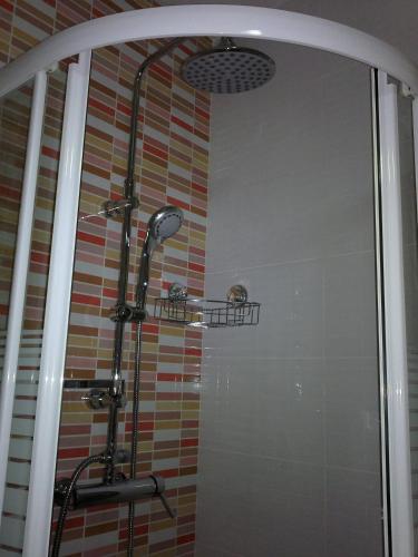 a shower with a glass door in a bathroom at Hotel Libertador in Cullera