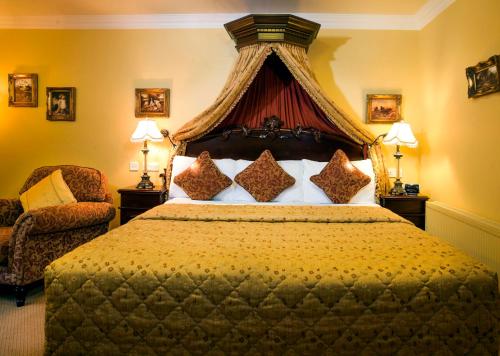 a bedroom with a large bed with a canopy at Earls Court House in Killarney