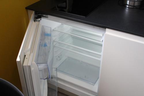 
an open refrigerator with a white refrigerator door at At home in lyon in Lyon
