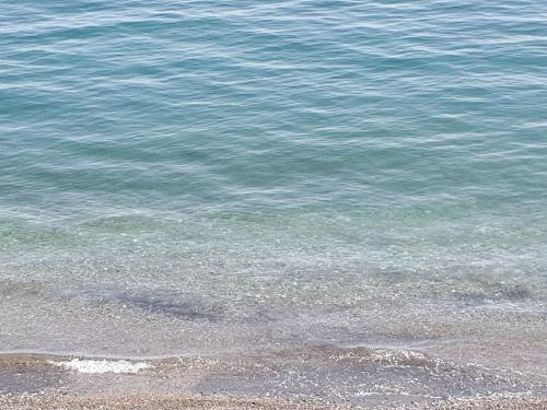 a body of water with a beach and the ocean at On the beach Sea-view&Kitchen In Room in Salerno