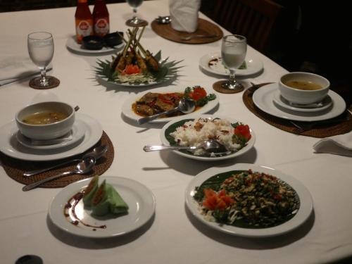 a table with plates of food on a table at Imani Villas in Canggu