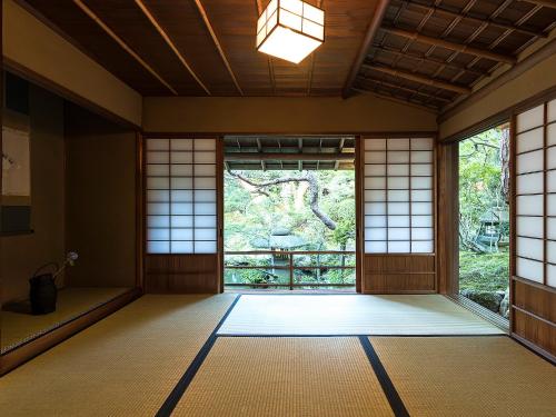 an empty room with a large window in a temple at Nanzenji sando KIKUSUI in Kyoto