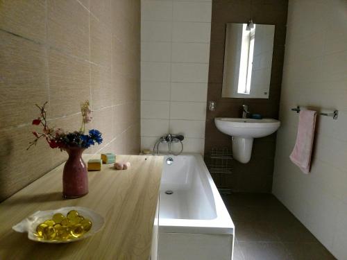 a bathroom with a tub and a sink and a bowl of fruit at Charming Rooms with a Seaview in Sliema