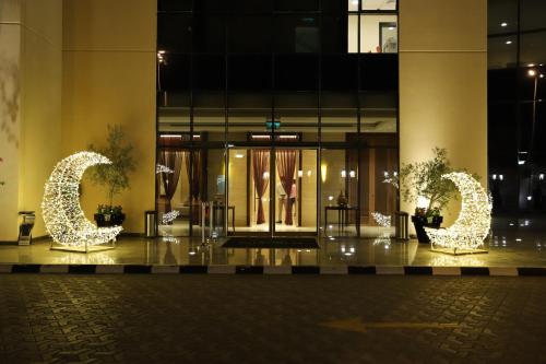 a lobby of a building with two sculptures of animals at Somewhere Hotel Al Ahsa in Al Hofuf