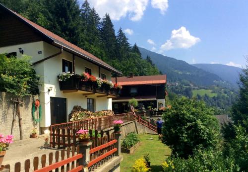 a house with a fence and flowers on it at Panoramahaus in Radenthein