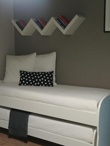 a bed with two shelves on the wall at Diadumeno Superior Apartment in Venosa