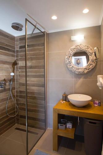 a bathroom with a sink and a shower at Elenis Philoxenia in Ixia