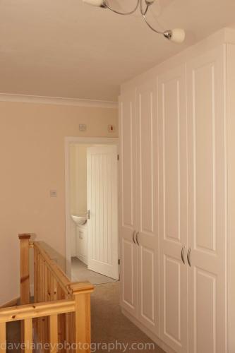 a hallway with a door and a sink in a room at Home from Home in Ilford