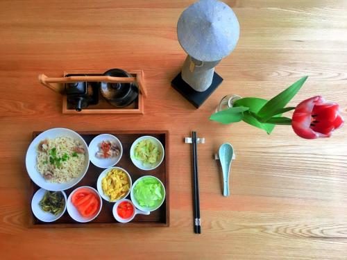 a tray of food with rice and vegetables on a table at Dan’s Sea Guest House Hangzhou in Hangzhou