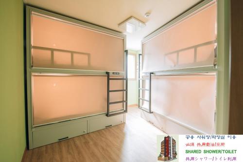 a closet with glass doors in a room at Daegu Midtown Hostel in Daegu