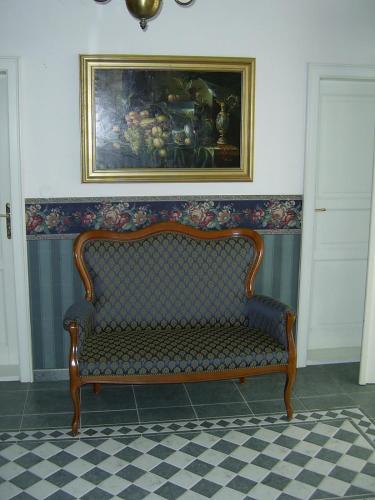 a couch in a room with a painting on the wall at Pension Šejko in Horní Planá