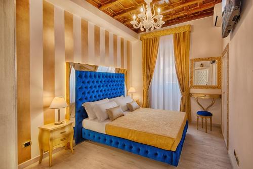 a bedroom with a blue bed in a room at Spanish Steps amazing Apartment in Rome