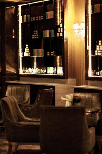 a restaurant with chairs and a table and a mirror at Dorsett Putrajaya in Putrajaya