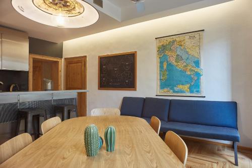 ein Esszimmer mit einem Tisch und einem blauen Sofa in der Unterkunft Casa Spinetta Malaspina - Verona Apartments in Verona