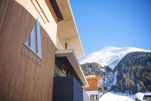 a building with the number on it with a mountain at Apart6580 in Sankt Anton am Arlberg