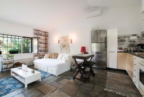 a living room with a white couch and a kitchen at Villa Irini in Sani in Sani Beach