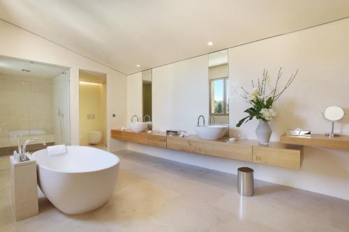 a large bathroom with a large tub and two sinks at MUSE Saint Tropez - Small Luxury Hotels of the World in Saint-Tropez