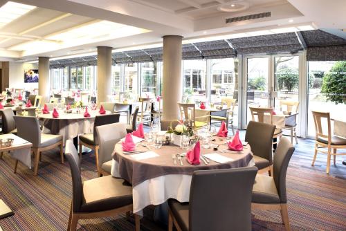 a restaurant with tables and chairs with red napkins at Domitys Paris Plaisance in Paris