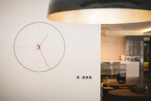 a clock on a wall in a room at Village Resort Hanuliak Apartmany in Belá