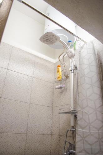 a shower with a shower head in a bathroom at Tamaris Holiday Home in Visoko