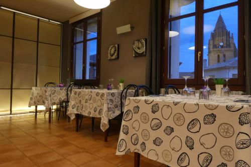 a room with tables and chairs and a building at Hospederia de Loarre in Loarre