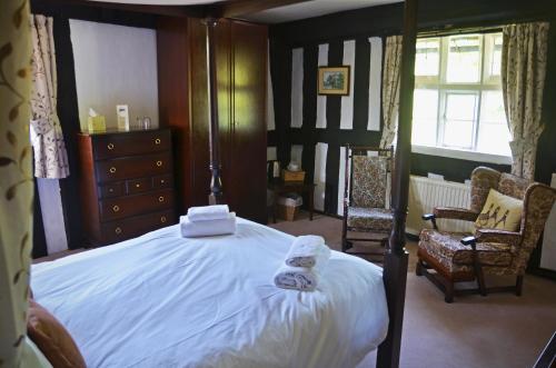 a bedroom with a bed with towels on it at Rhydspence in Hay-on-Wye