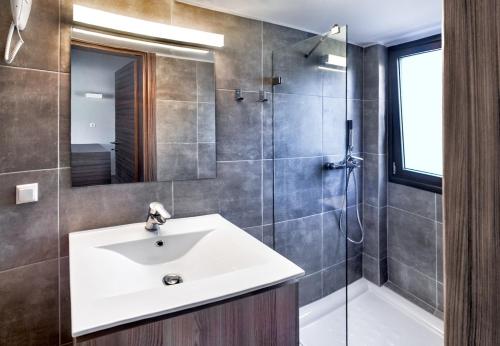 a bathroom with a sink and a shower at Sani Woods Studios & Apartments in Sani Beach