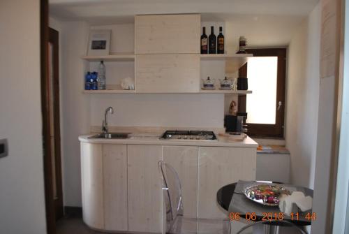 a kitchen with a sink and a counter with a table at Bed & Breakfast StudioArcodia- in San Marco dʼAlunzio