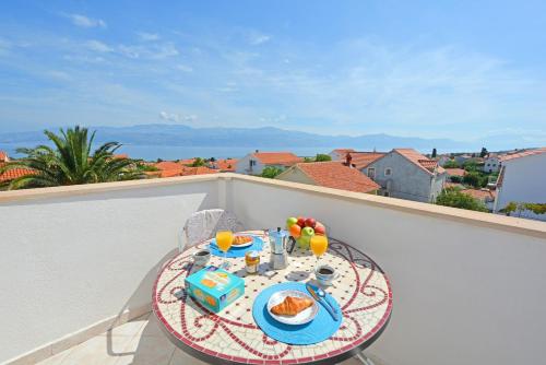a table with food and drinks on a balcony at ꕥ Apartments Residence SUNCE Supetar, Family choice - cozy base to stay and explore island Brac FREE PARKING in Supetar