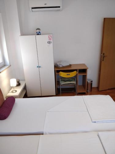 a room with a desk and a white refrigerator at Savski Gaj in Zagreb