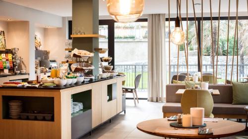 a kitchen with a table with food on it at Flora Hotel & Suites in Merano