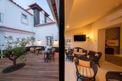 two views of a patio with chairs and tables at Pousada Vila Óbidos in Óbidos