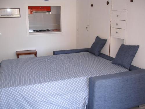 a bedroom with a blue bed with blue pillows at Primavera - Zand Properties in Benidorm