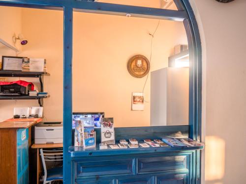 a blue cabinet with a mirror in a room at Princess Sissy in Ios Chora
