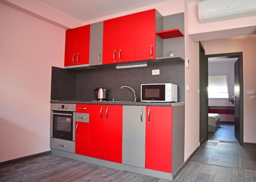 a kitchen with a stove top oven and a refrigerator at Visito Aparthouse in Sofia