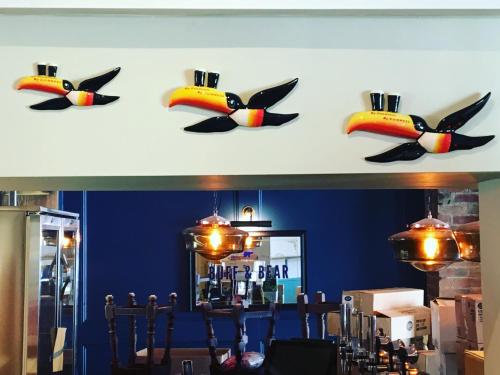 a wall with a bunch of bird heads on it at The Dolphin in Newbury