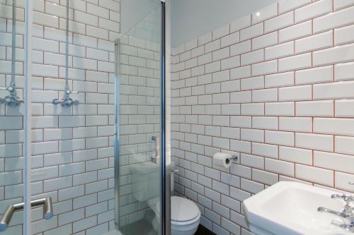 a bathroom with a toilet and a glass shower at The Dolphin in Newbury