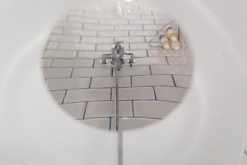 a mirror in a bathroom with a bath tub at The Dolphin in Newbury