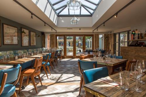 a row of tables and chairs in a restaurant at The Dolphin in Newbury