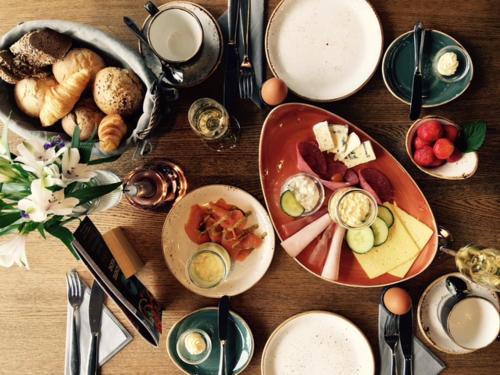a wooden table with plates of food on it at Apartment Yachthafen Waren in Waren