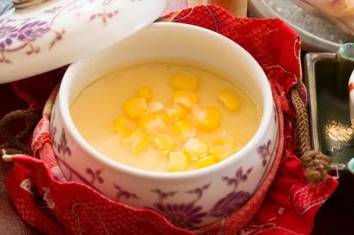 a cup of soup with corn in it on a table at Kurokawa Onsen Ryokan Ichinoi in Minamioguni